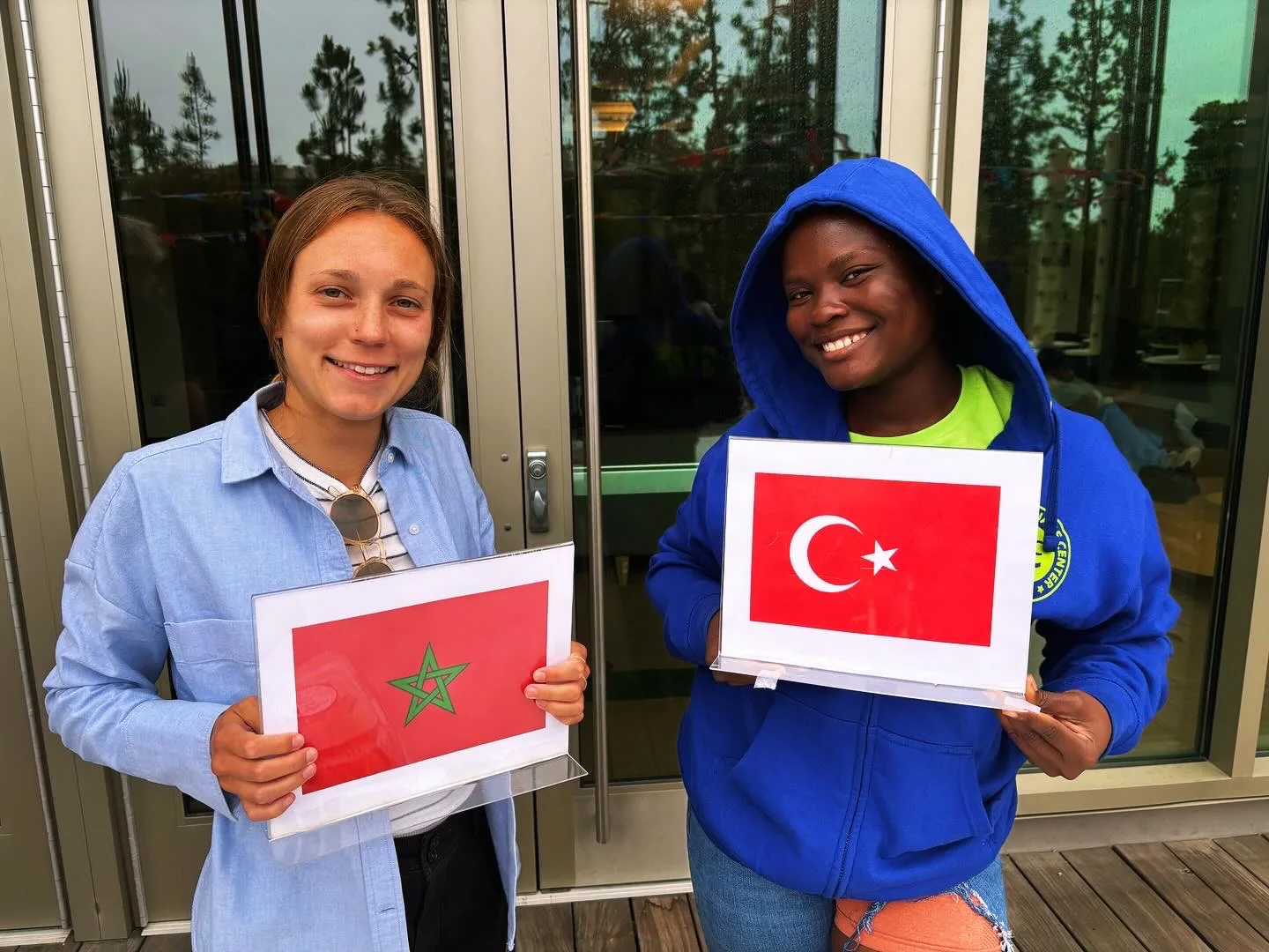 Two students holding printed flags of Morocco and Turkey at ELC culture day at UCLA