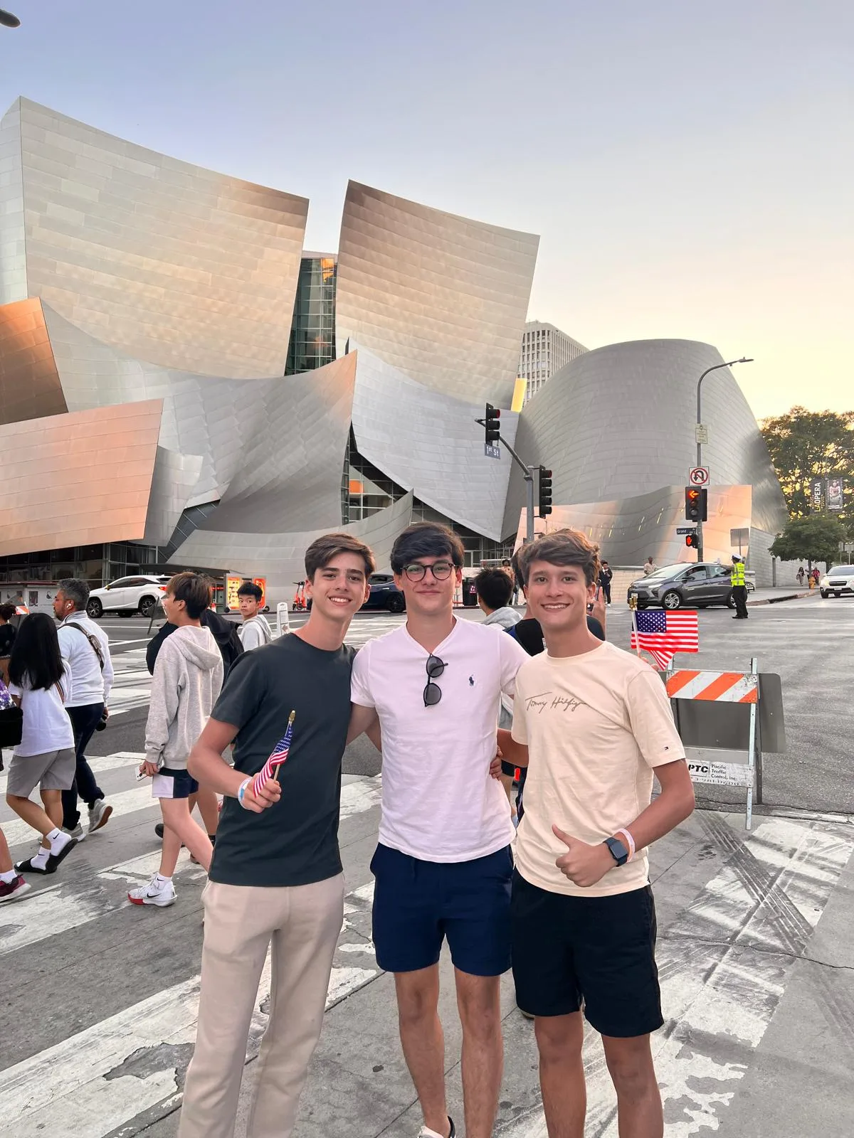 Three students outside the Walt Disney Concert Hall in downtown Los Angeles at dusk