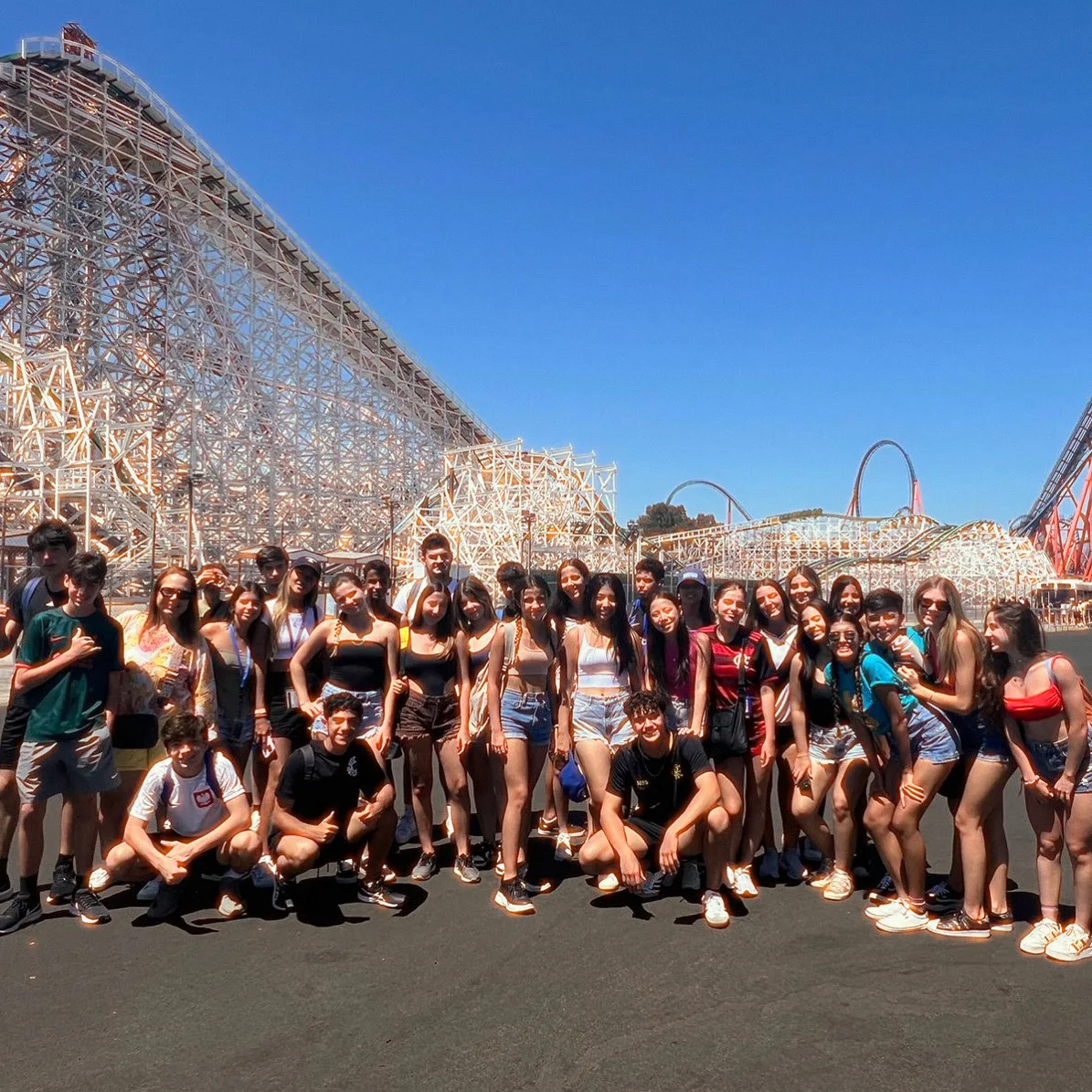 ELC students in front of a wooden roller coaster on a theme park excursion near Los Angeles
