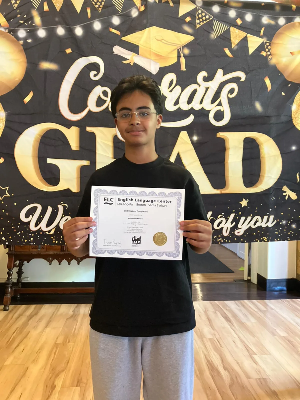 A student holding an ELC certificate of completion at the end of the summer program at UCLA
