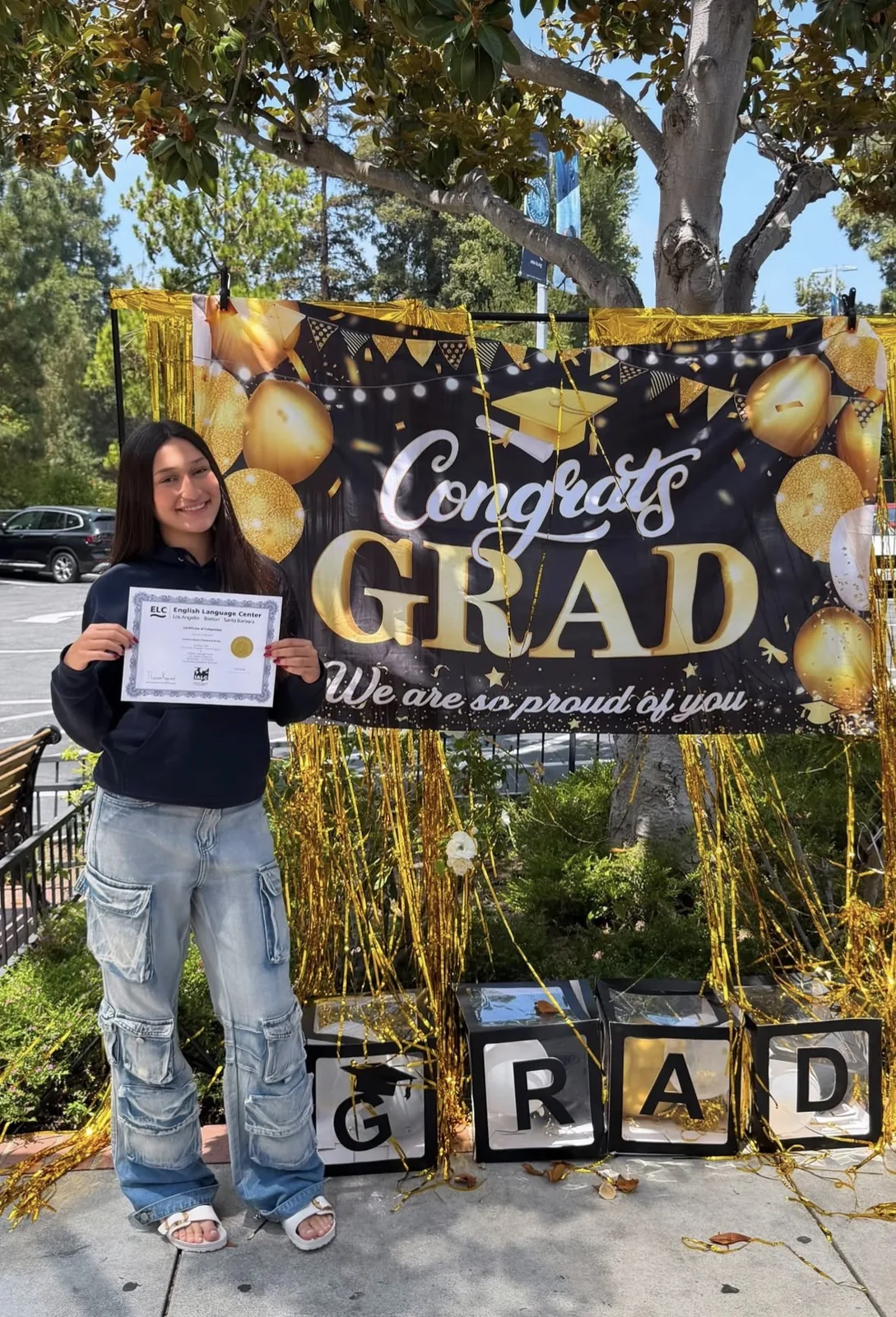 An ELC student with her completion certificate on graduation day