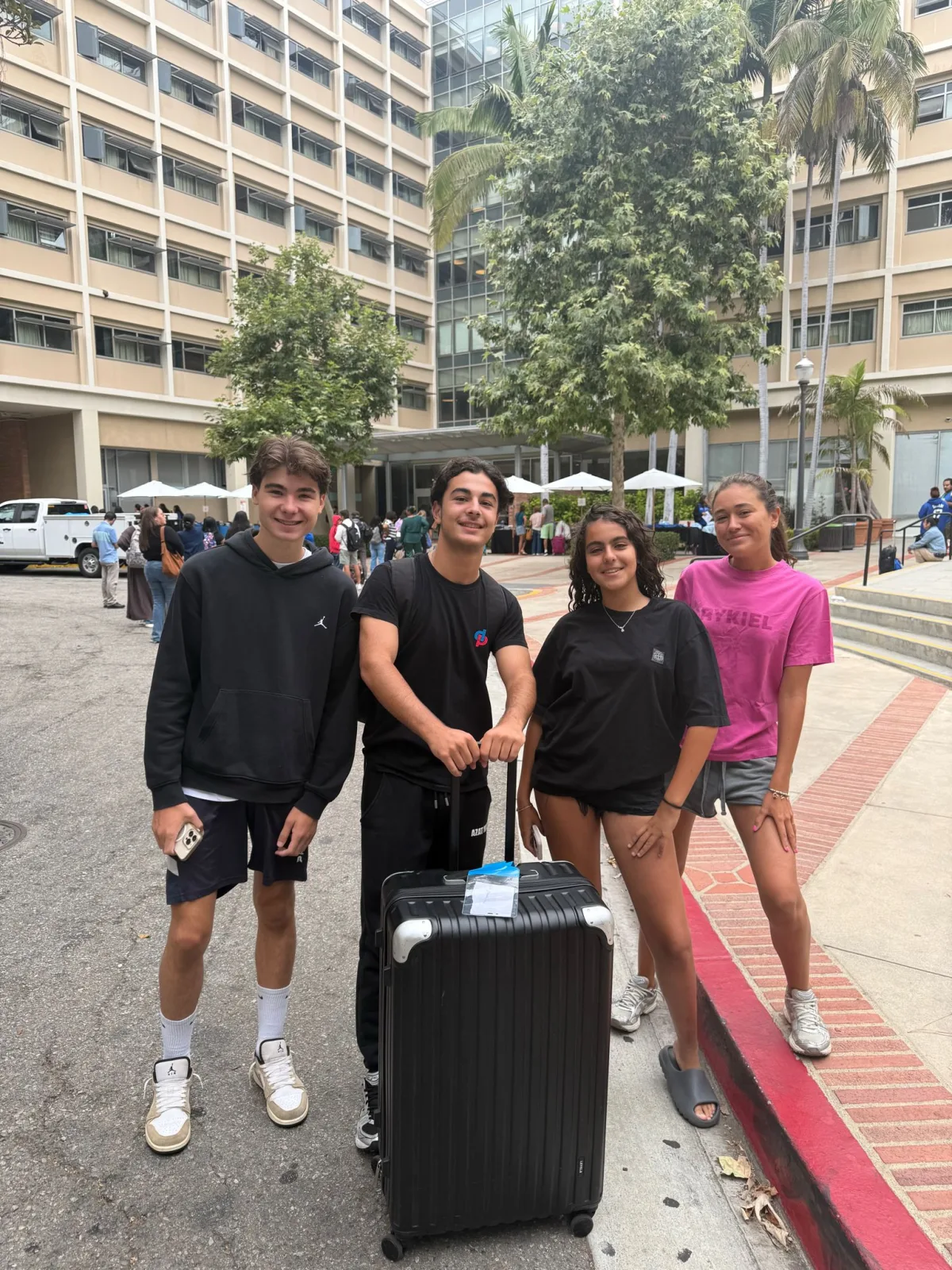 Students with their luggage outside the UCLA residence halls on arrival day